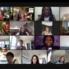 Screenshot of a virtual video conference with 13 diverse participants in individual frames, each in different indoor environments, some with personal touches in their background.